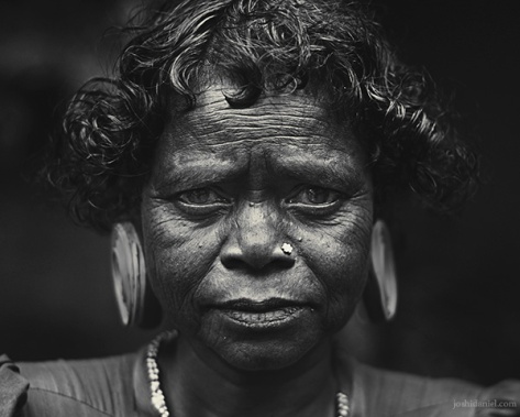 Black and white portrait of a Paniya woman with a large ear plug from Wayanad, Kerala